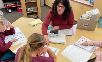 Elementary teacher providing small-group reading instruction