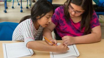 two elementary students filling out a strategy chart class