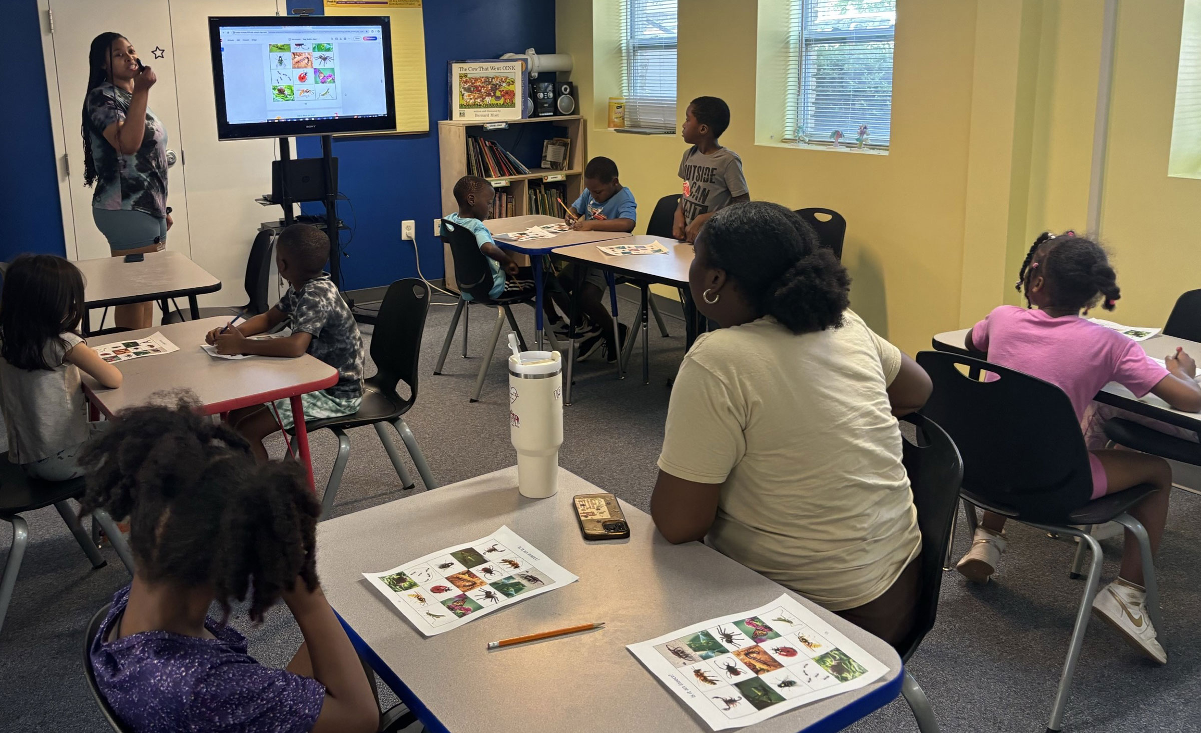 Young kids in summer classroom learning about bugs