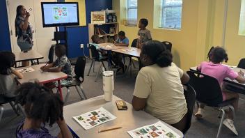 Young kids in summer classroom learning about bugs