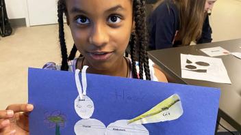 Young girl showing her model of insect parts